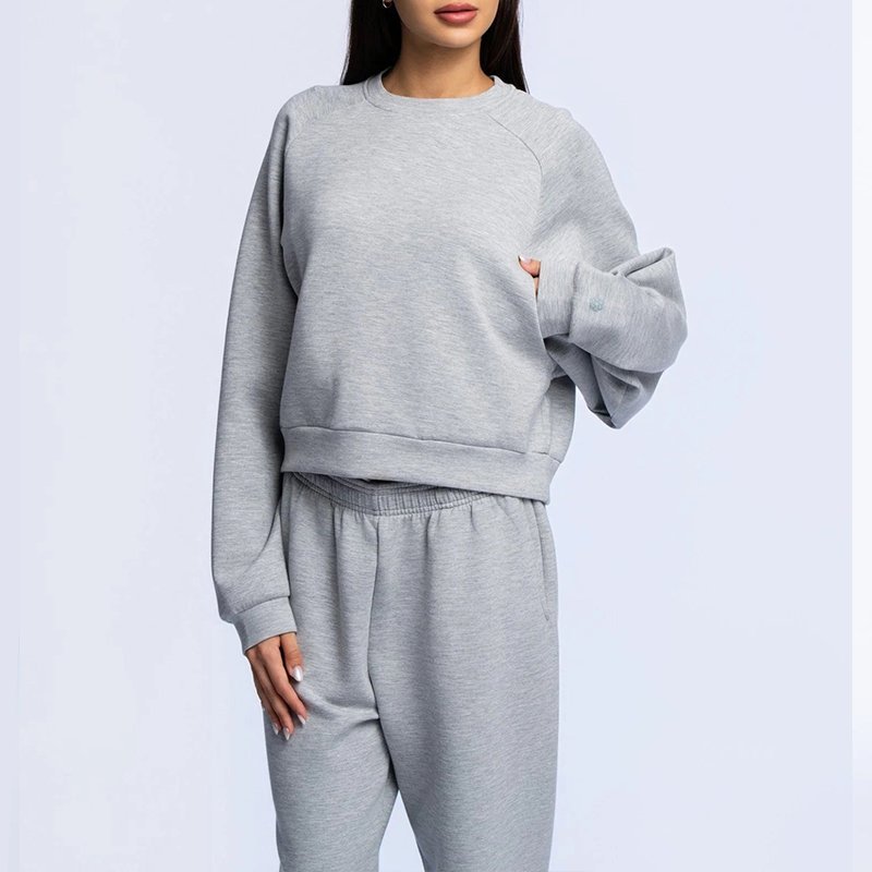 Ribbed cuff and raglan sleeve detail on a heather grey melange crewneck sweatshirt lounge set