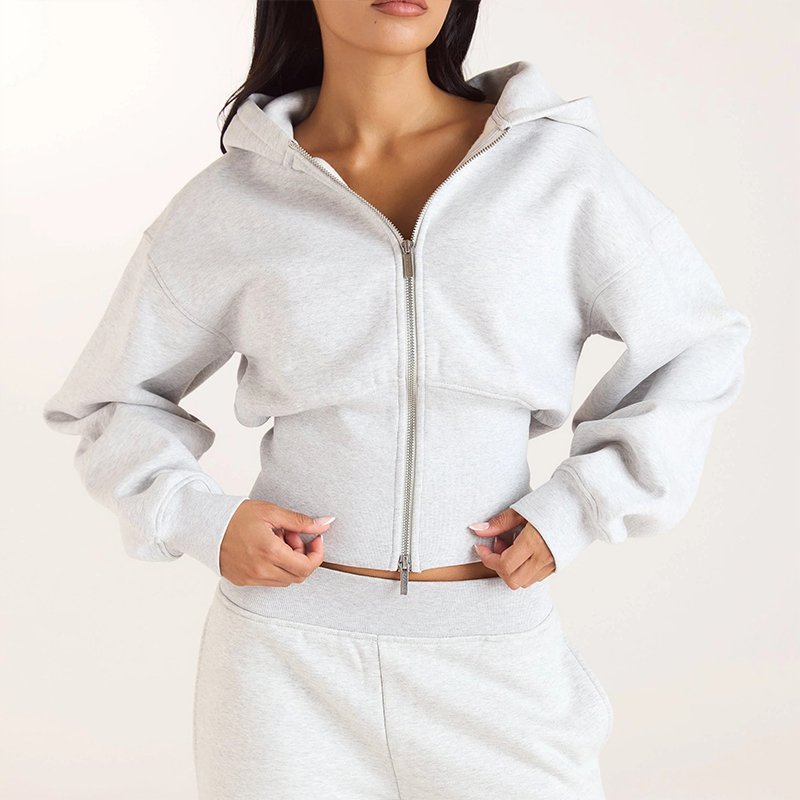 Fitted ribbed waistband and full length zip detail on a pearl grey cropped zip-up hoodie