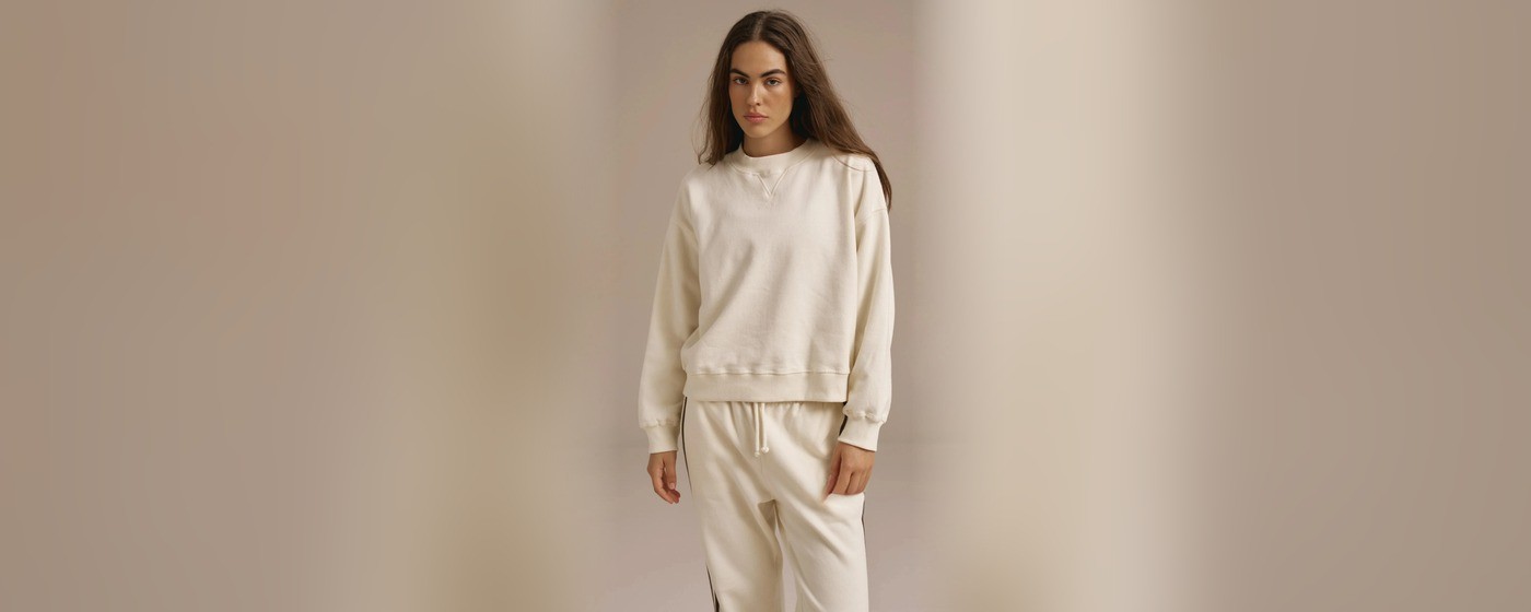 Cream oversized crewneck sweatshirt with a V stitch neckline and matching side striped sweatpants