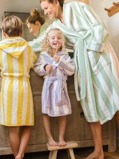 Family wearing striped cotton terry bath and spa robes after bathing