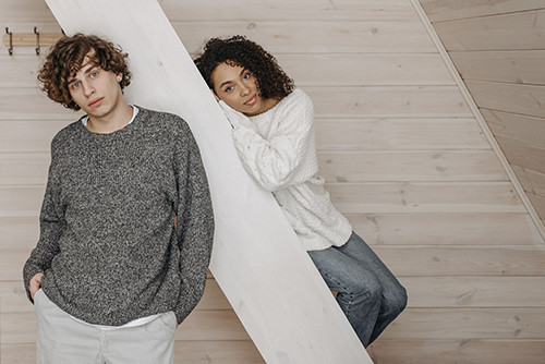 Two models wearing chunky knit sweaters ready for private label sweater production