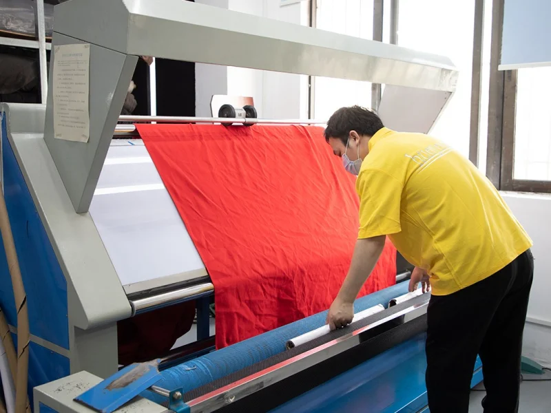 Fabric roll being inspected for weight and shade on the fabric checking machine at the KoalaPurr factory