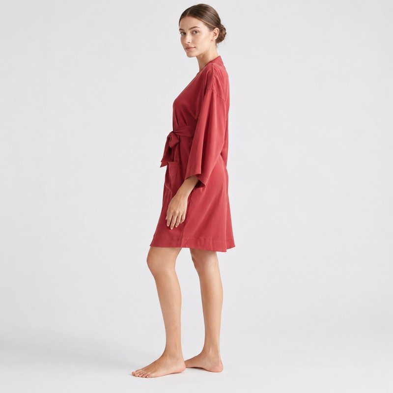 Self-tie belt and side drape detail on a brick red short satin robe