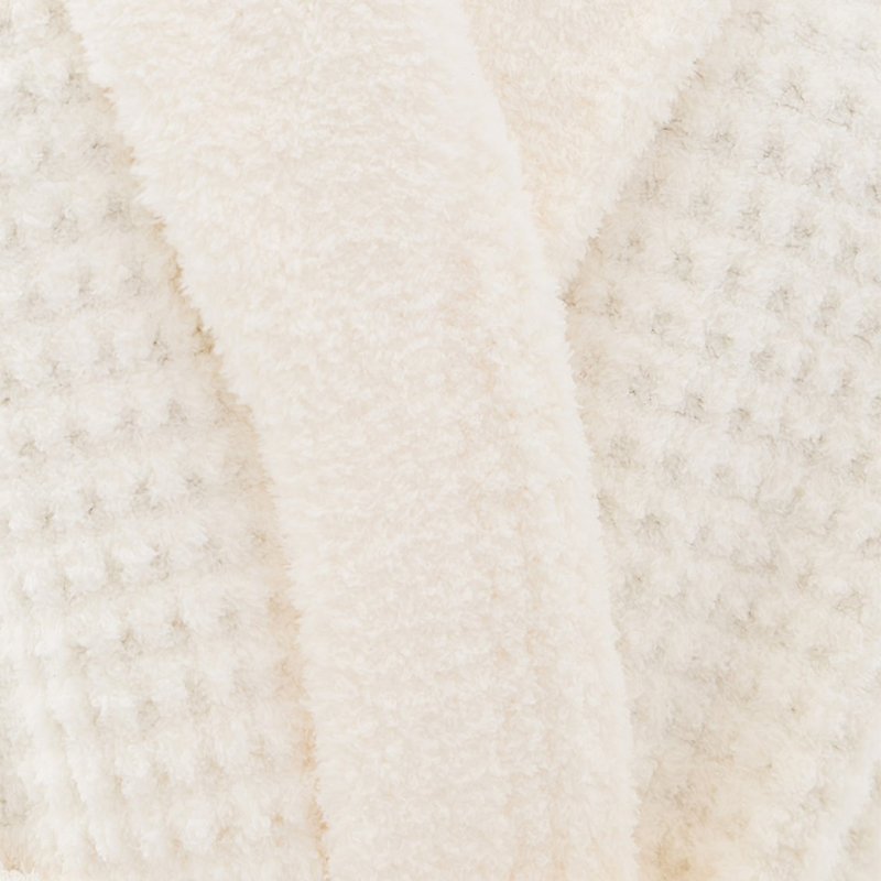 Close-up of raised waffle grid texture on a cream cotton blend robe