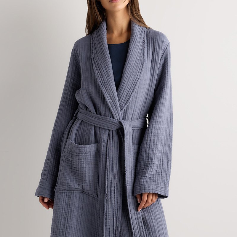 Close-up of the raised waffle cell texture on a mist blue cotton robe