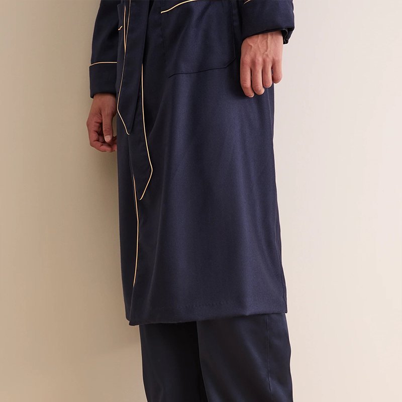 Close-up of contrast piping along the collar and belt of a navy men's robe