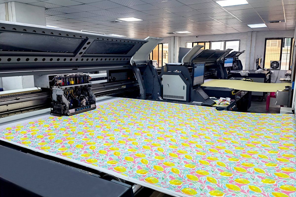 Digital textile printer printing a yellow lemon pattern onto fabric in a pajama factory