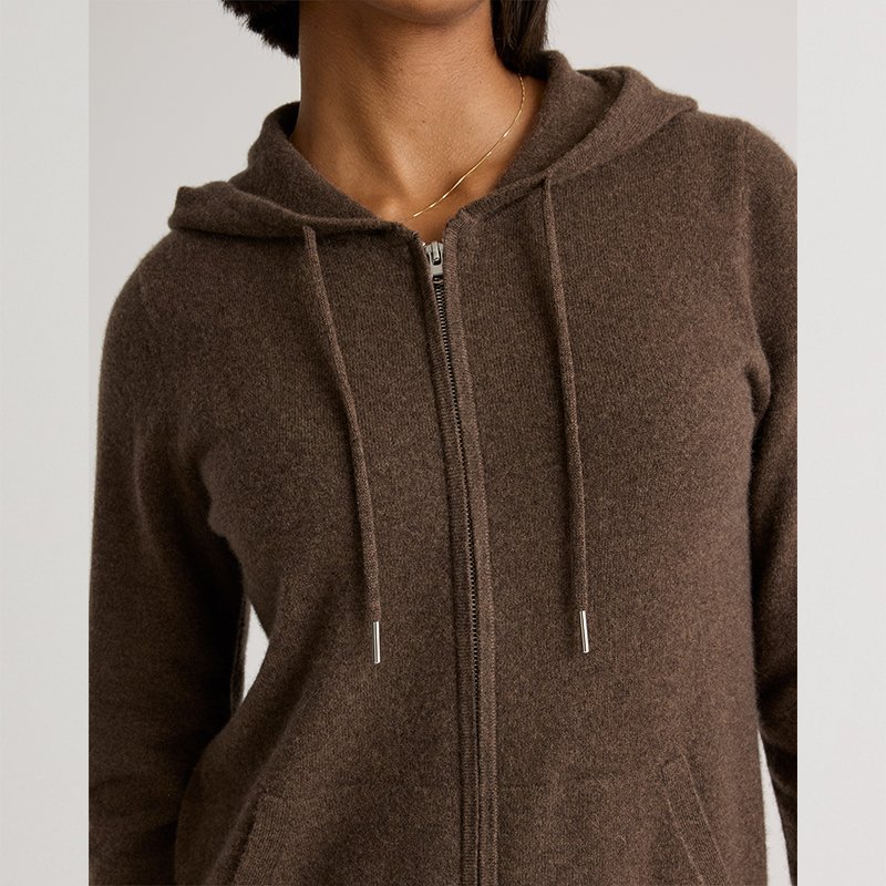 Close-up of the full-length metal zip and ribbed placket on a cashmere hoodie