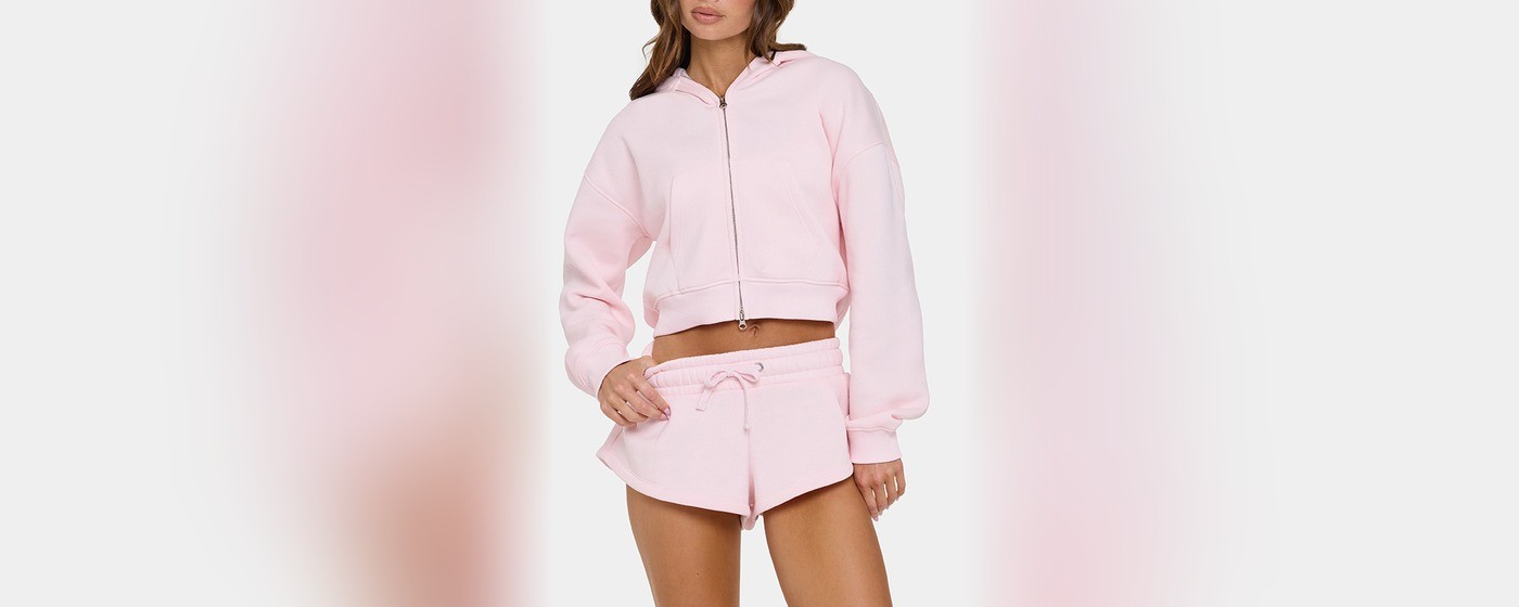 Women's cropped pink zip-up hoodie with dropped shoulders and a metal zip