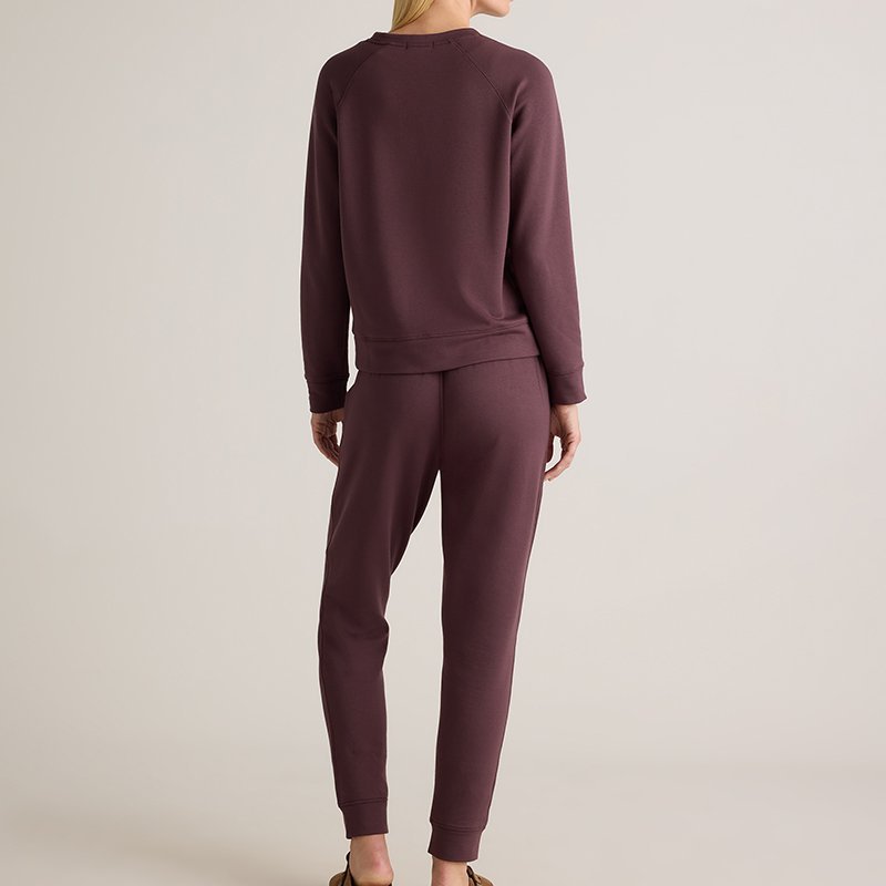 Close-up of the ribbed cuff and fleece surface on a fig brown sweatshirt