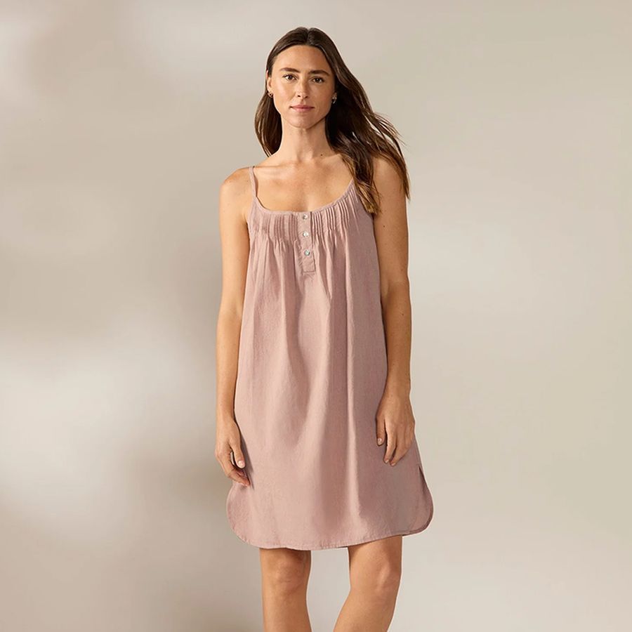 Woman wearing a blush cotton nightgown with a pintucked bodice