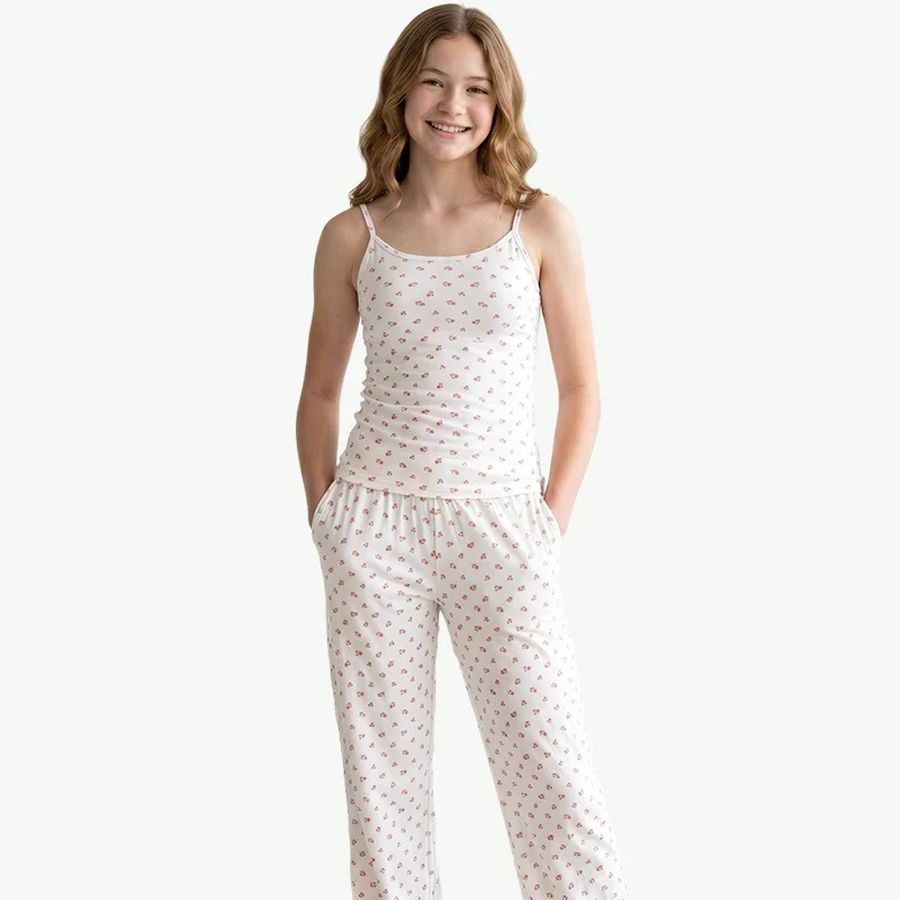 Teen girl in a white floral camisole and pant pajama set