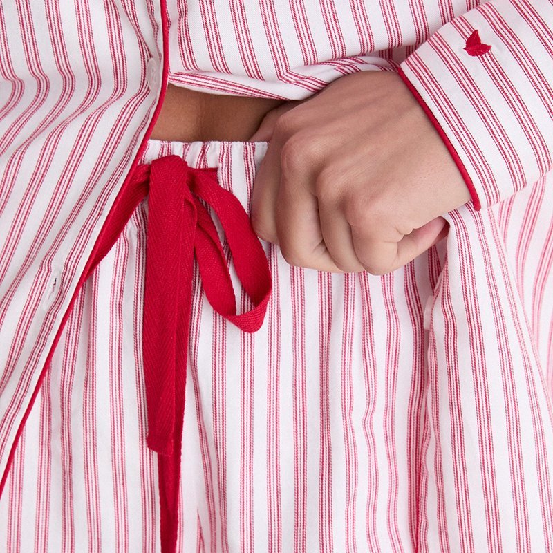 Close-up of the red ribbon drawcord on the ticking stripe pajama pants