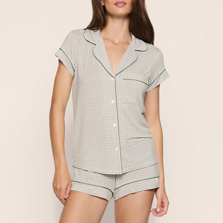 Short pajama set with a short-sleeve button-up top, contrast piping and matching piped shorts