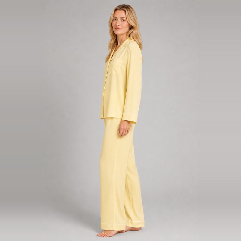 Side view of a yellow lyocell pajama set showing the relaxed shirt and long pants