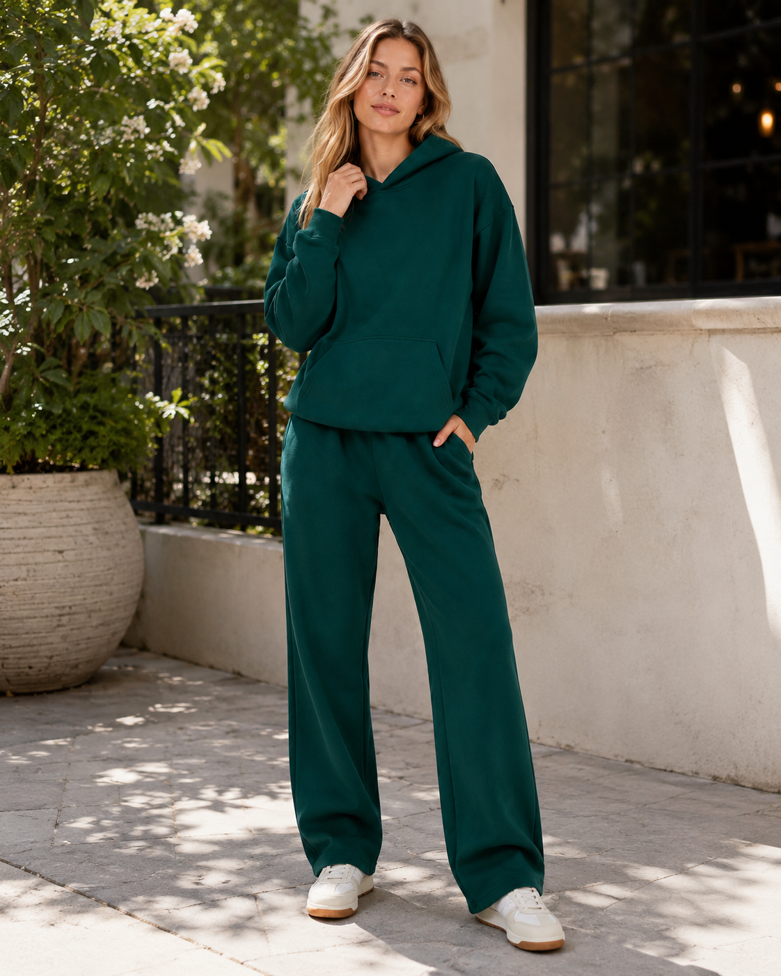 Detailed view of French terry hoodie and sweatpants showing smooth knit texture, ribbed trims, elastic waist and pocket construction