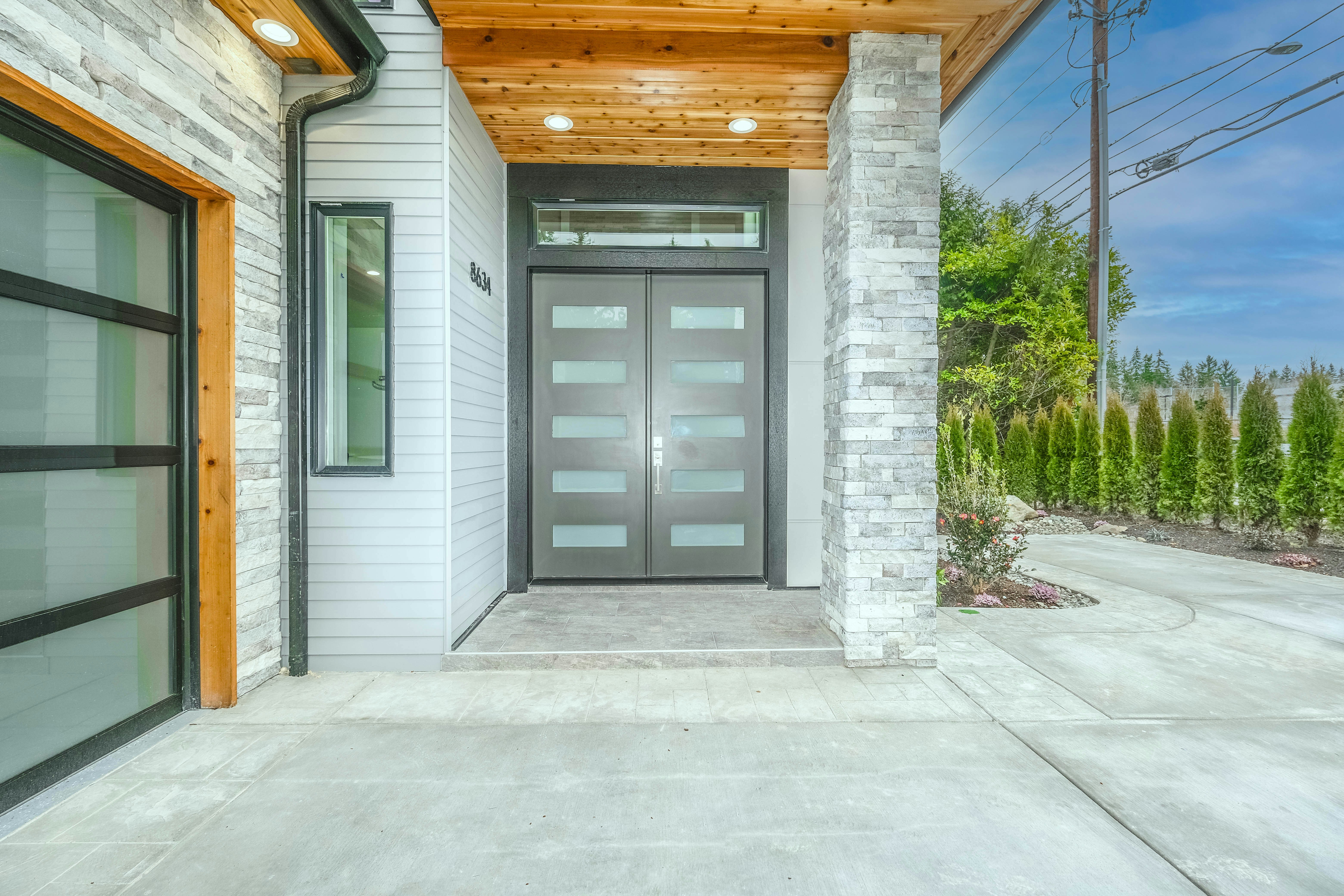 A modern home with a sleek aluminum entry door and a traditional home with a compatible aluminum door.