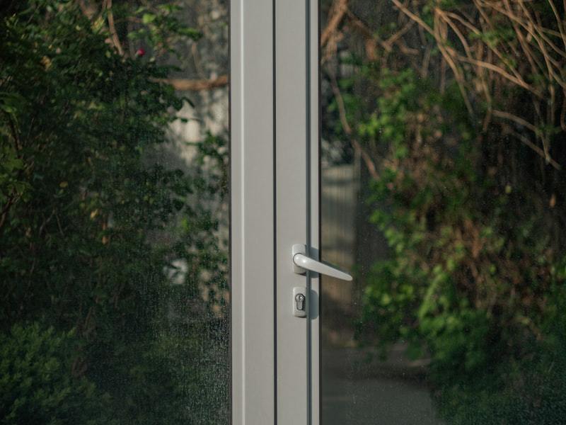Door handle and locking hardware on an aluminum entry door