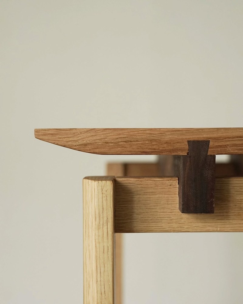Close-up of the wood tabletop edge and contrasting joint detail