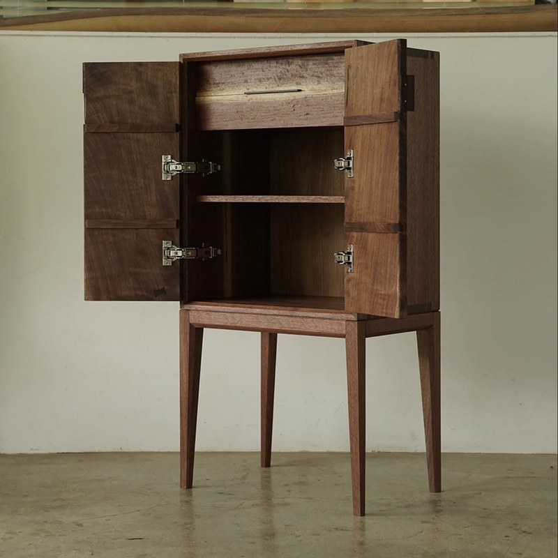 Open cabinet showing the interior drawer and shelf