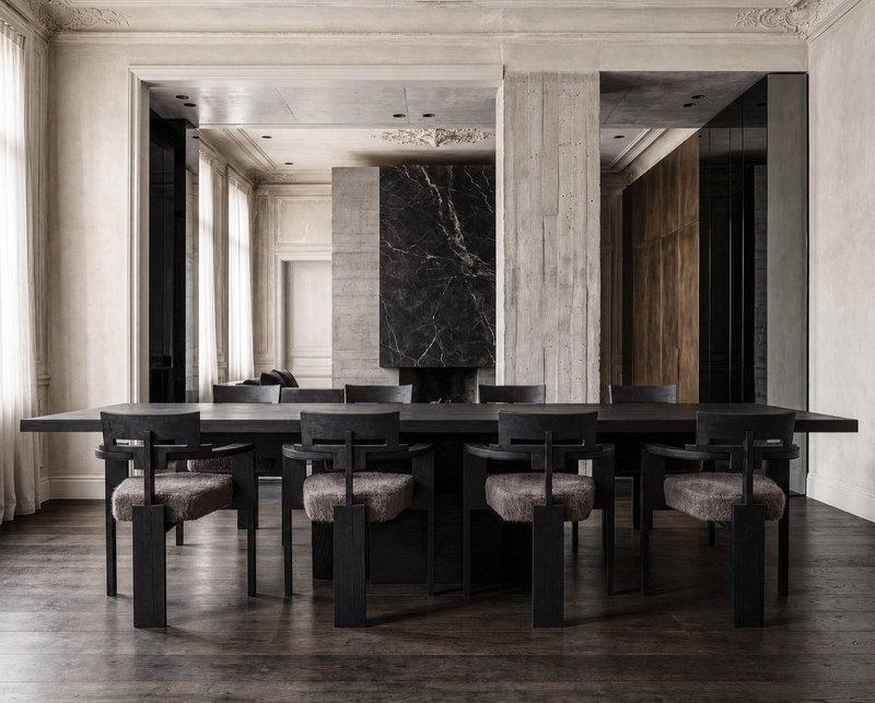 Black wood dining table with geometric base and coordinating dining chairs