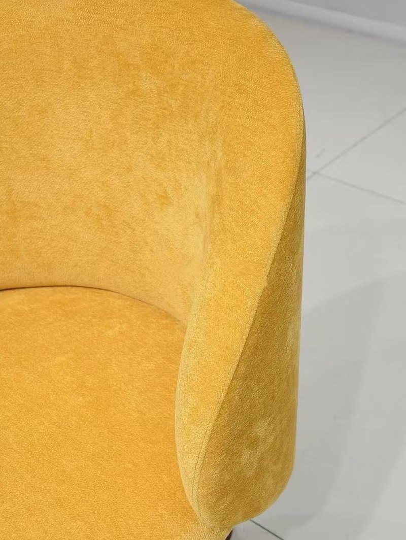 A Curved-Back Accent Chair with a Warm, Sculptural Profile material detail