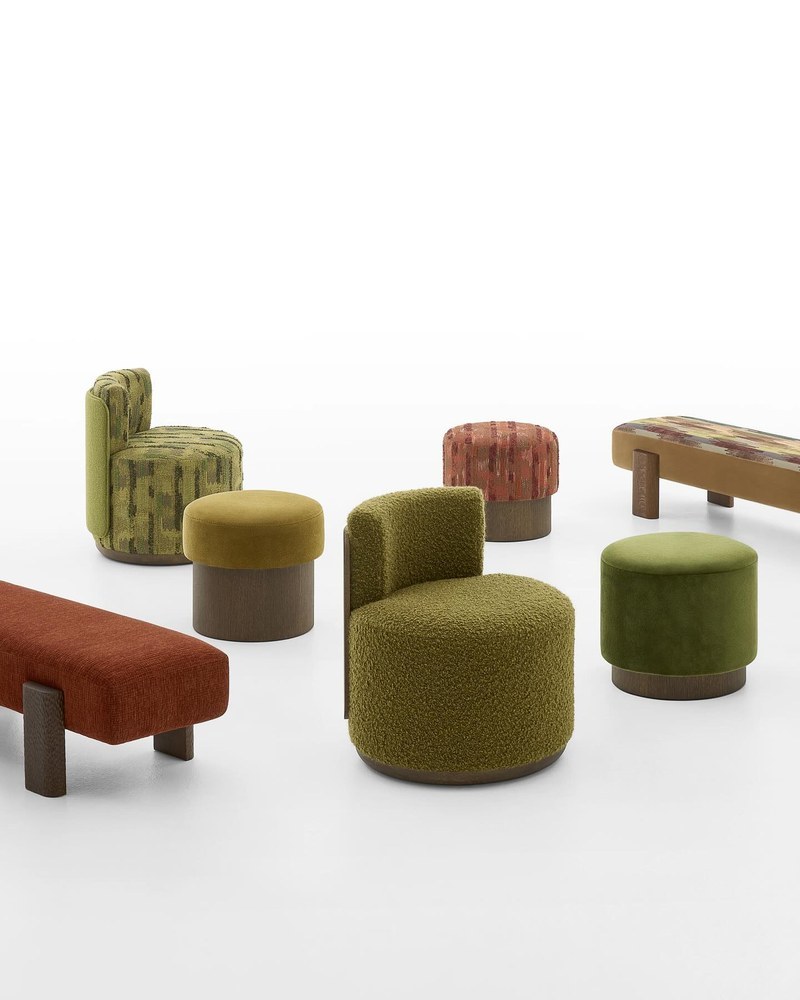 Coordinated hospitality seating collection with round upholstered chairs, cylindrical stools and benches