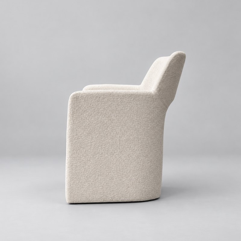 Side profile of the upholstered hotel armchair showing the integrated arm and sloped backrest