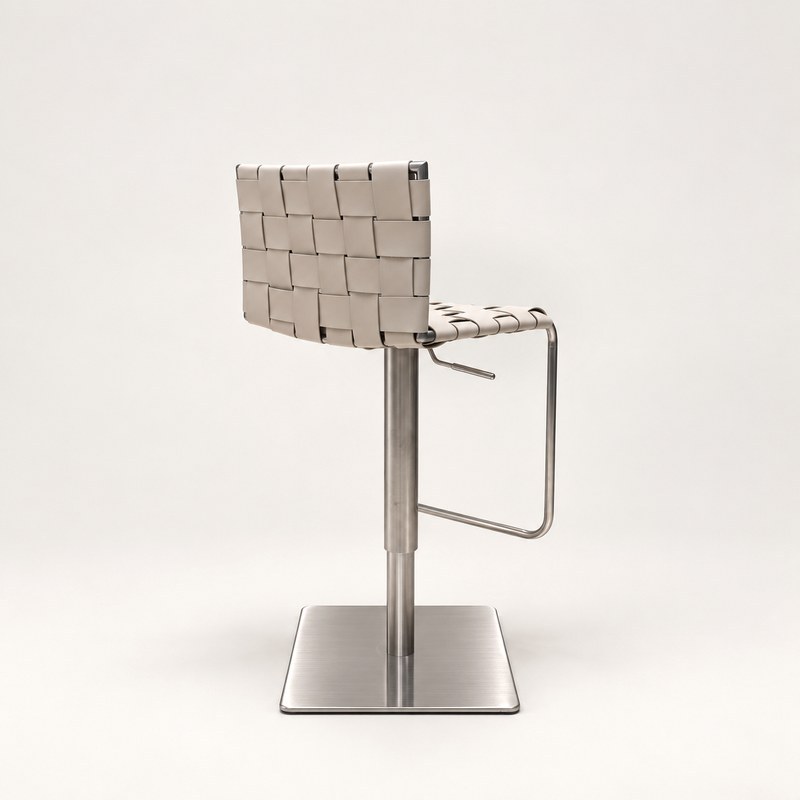 Side view of a woven strap bar stool with an open metal support and square base