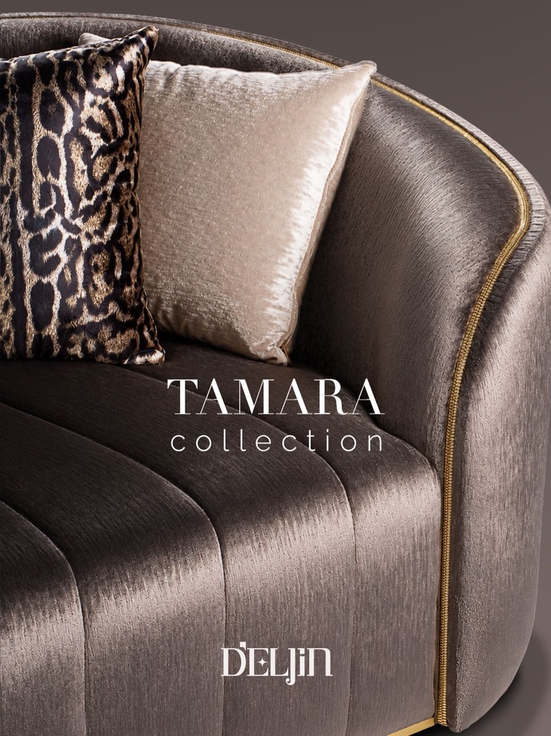 Close-up of a curved hotel sofa arm with gold-tone piping and velvet-look upholstery