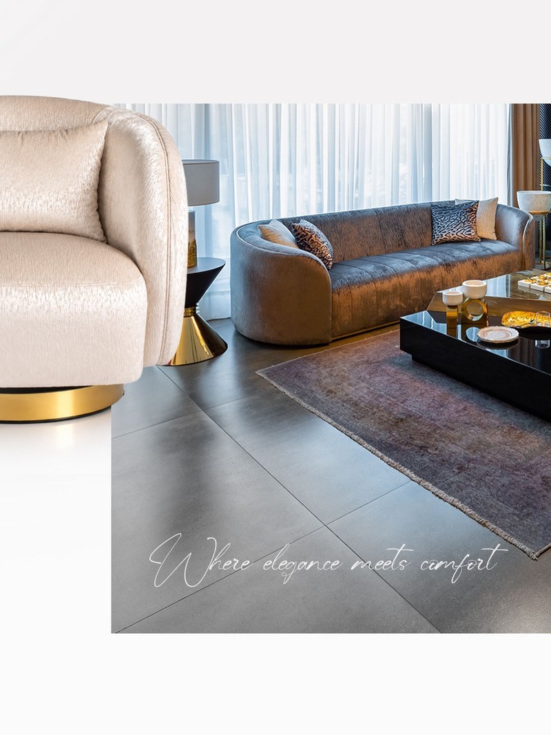 Contemporary hotel suite lounge with a curved upholstered sofa and a black coffee table