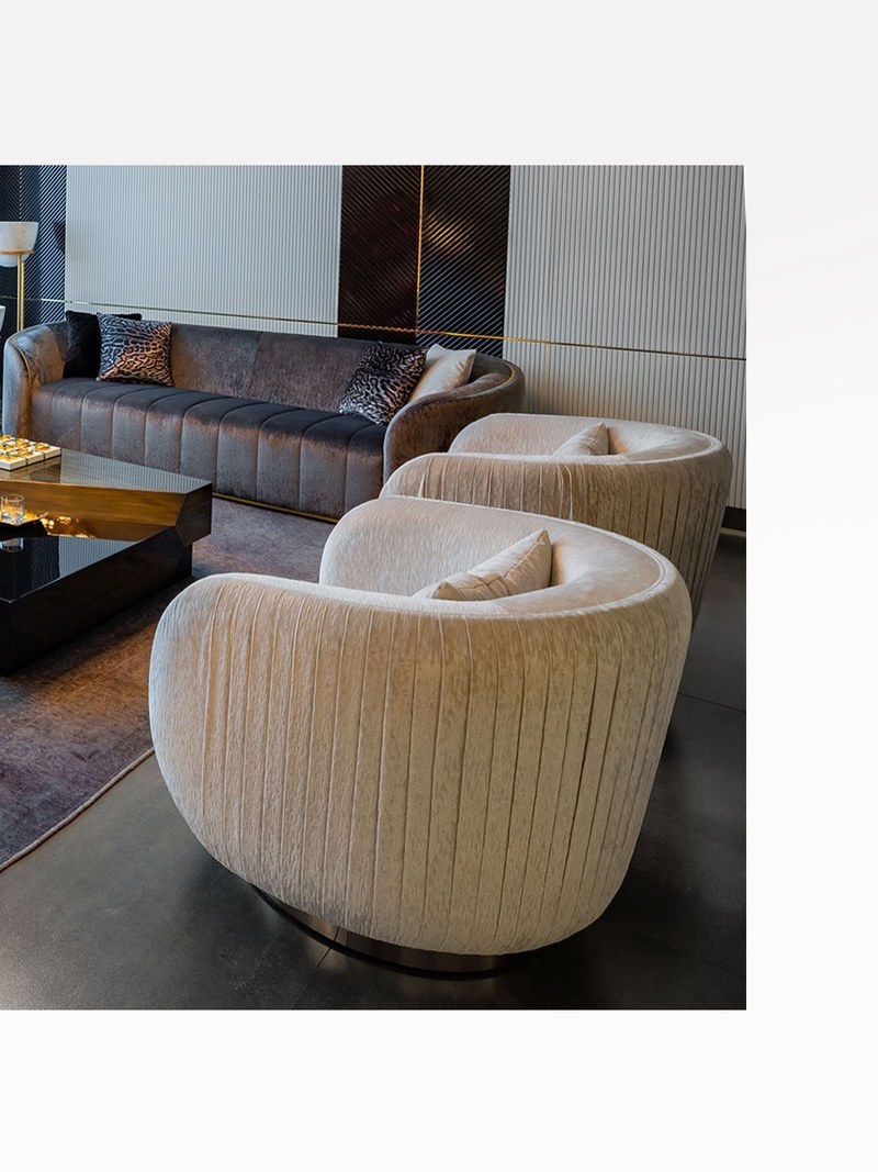 Hotel suite seating group with a channel-upholstered sofa and two ivory swivel lounge chairs