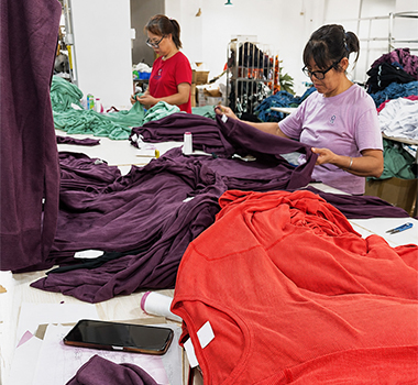 Garment workers checking apparel during bulk production