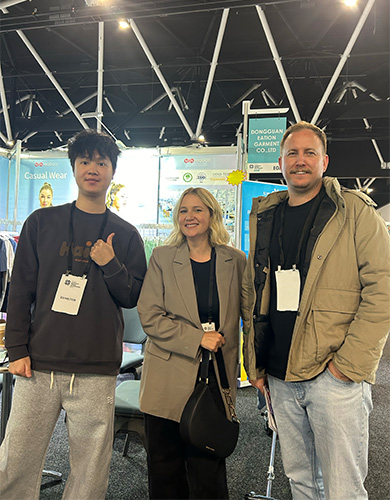 MinCharm team meeting international buyers at an apparel exhibition in Australia in 2025