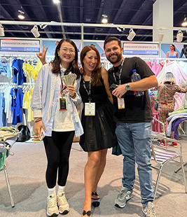 MinCharm team with visitors at MAGIC Las Vegas apparel trade show in 2025