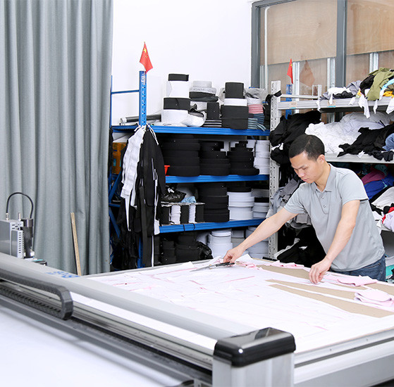 Worker preparing garment pieces during sample development at MinCharm's Dongguan factory