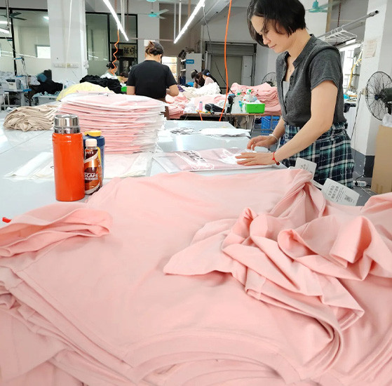 Workers checking and organizing garments during private label bulk production at MinCharm