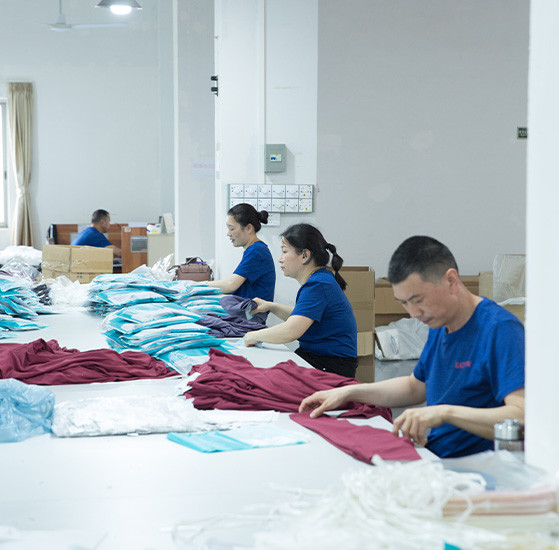 Workers preparing garments and packaging during private label apparel production at MinCharm