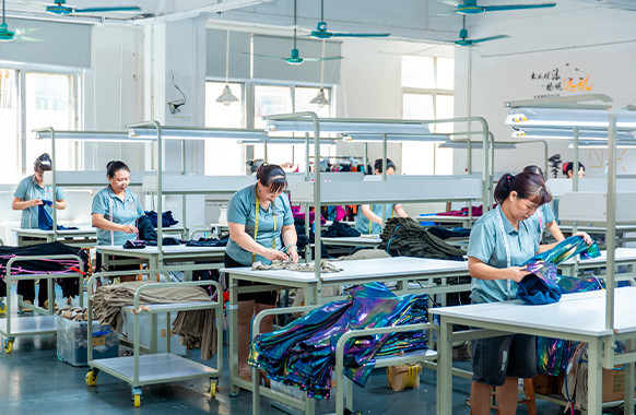 Workers checking garments during apparel production at MinCharm