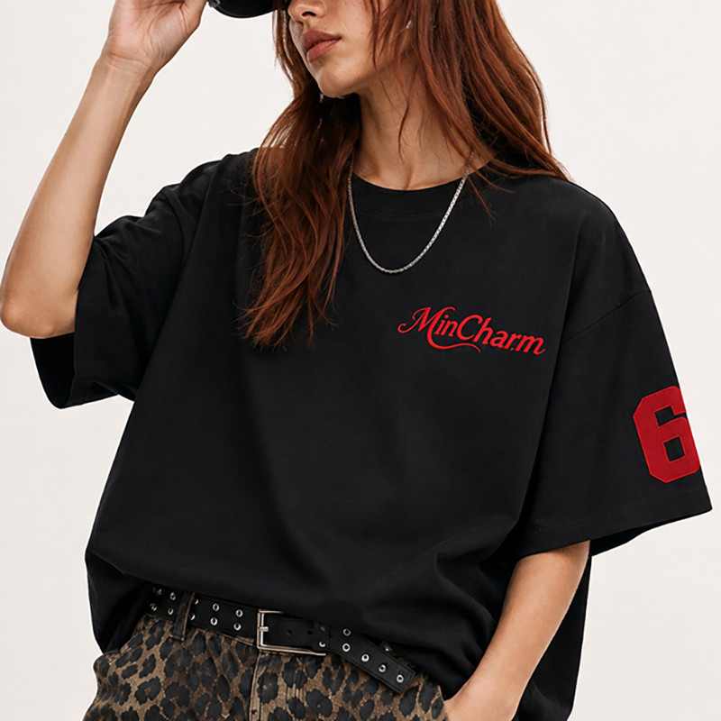 Close view of embroidered chest logo on women’s oversized T-shirt