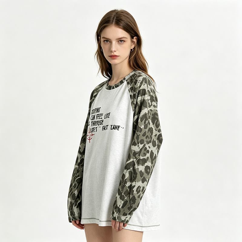 Side view of women's contrast sleeve graphic raglan sweatshirt