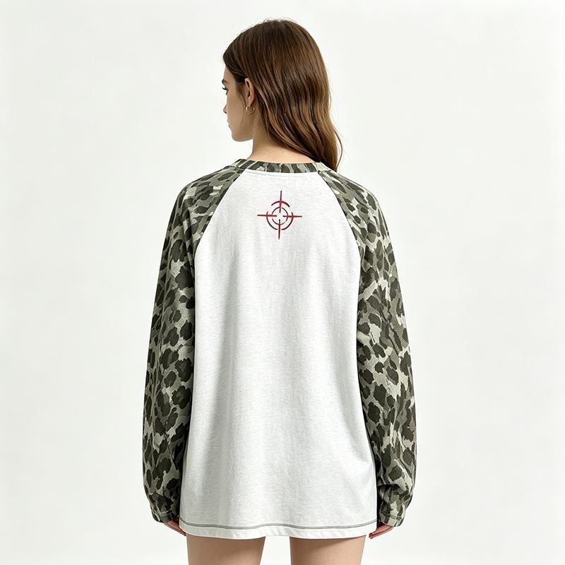 Back view of women's graphic raglan sweatshirt with contrast patterned sleeves