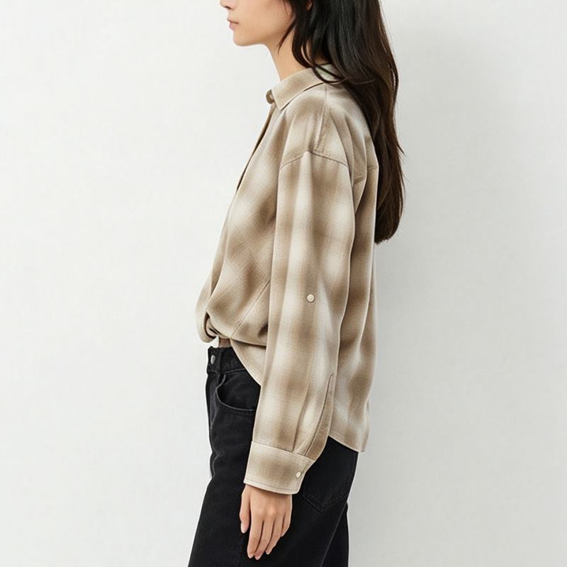 Side view of women's beige plaid shirt with roll-tab sleeve