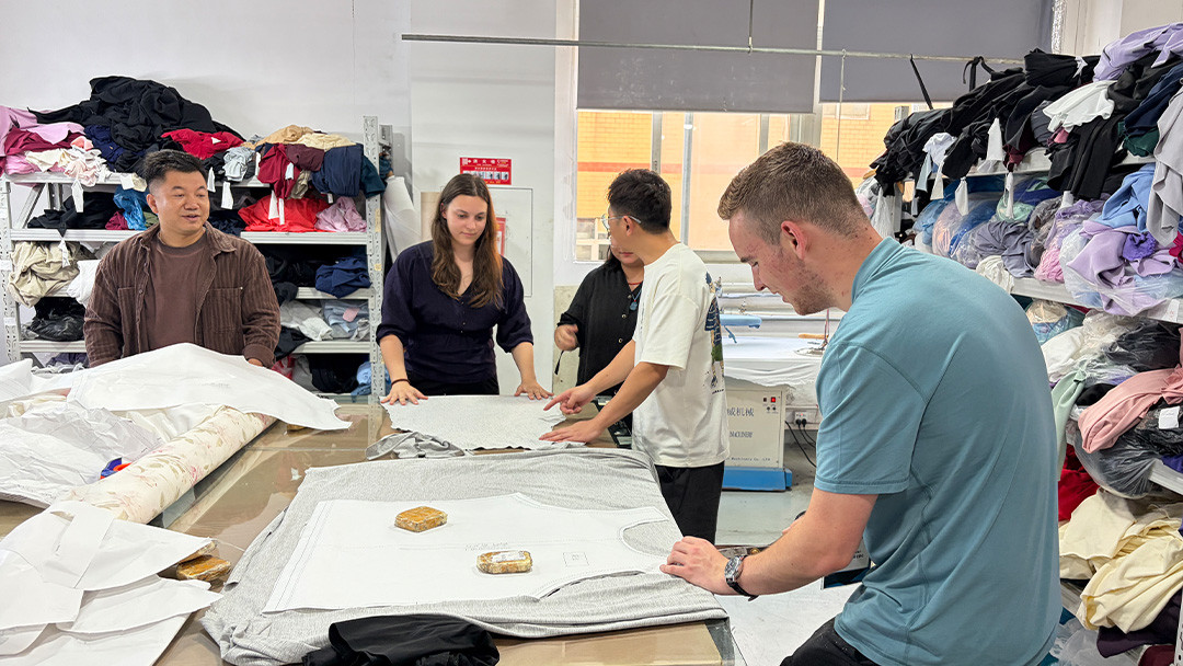 Students learning about garment patterns and apparel development during the MinCharm factory visit