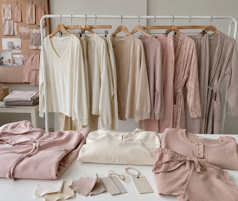 Neutral-toned loungewear collection with tops, pants, robes and fabric swatches