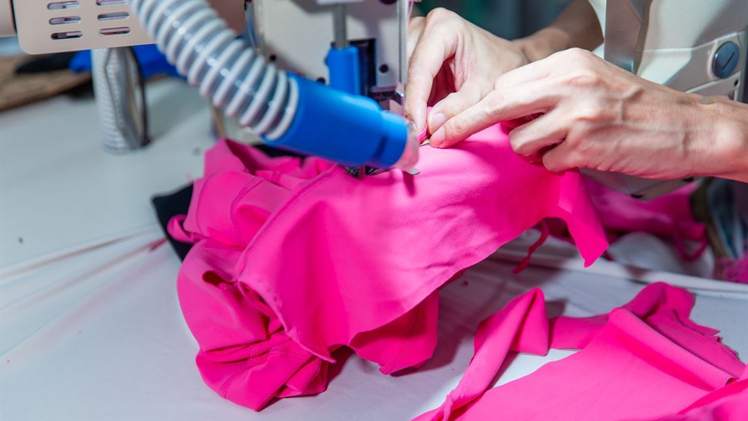 Close-up garment sewing workmanship for custom apparel production