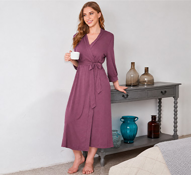 Woman wearing a dusty rose belted robe with textured fabric