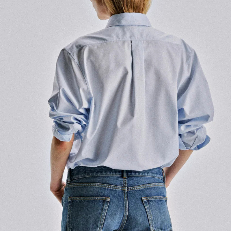 Back view of women's long sleeve textured shirt