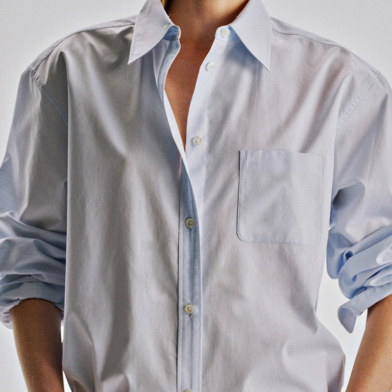 Exposed button placket and chest pocket detail on textured women's shirt