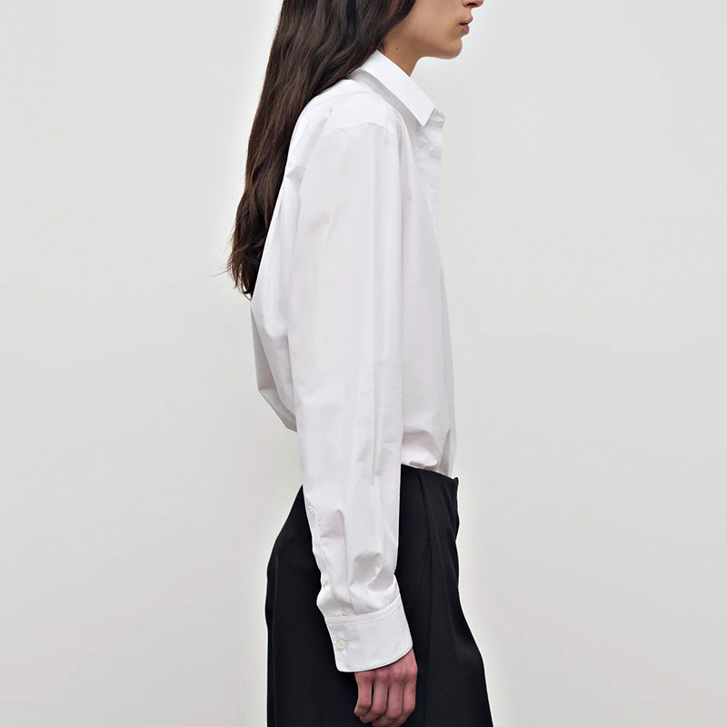 Side view of the white long sleeve button-front shirt